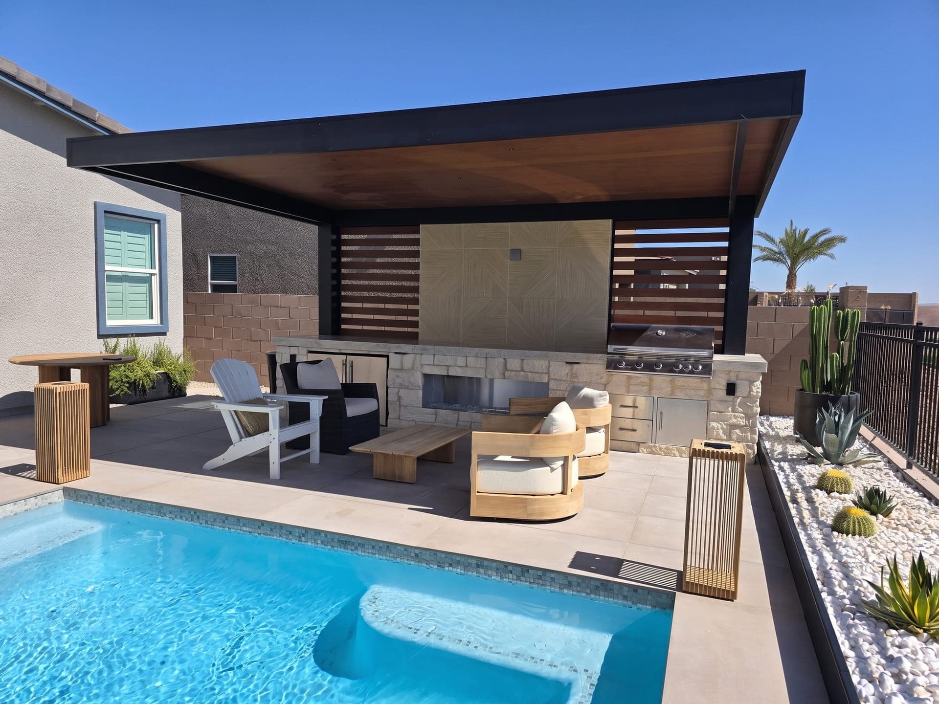 4K Aluminum cantilever cover with a solid roof, wood-look ceiling and slat privacy walls over an outdoor kitchen by a pool